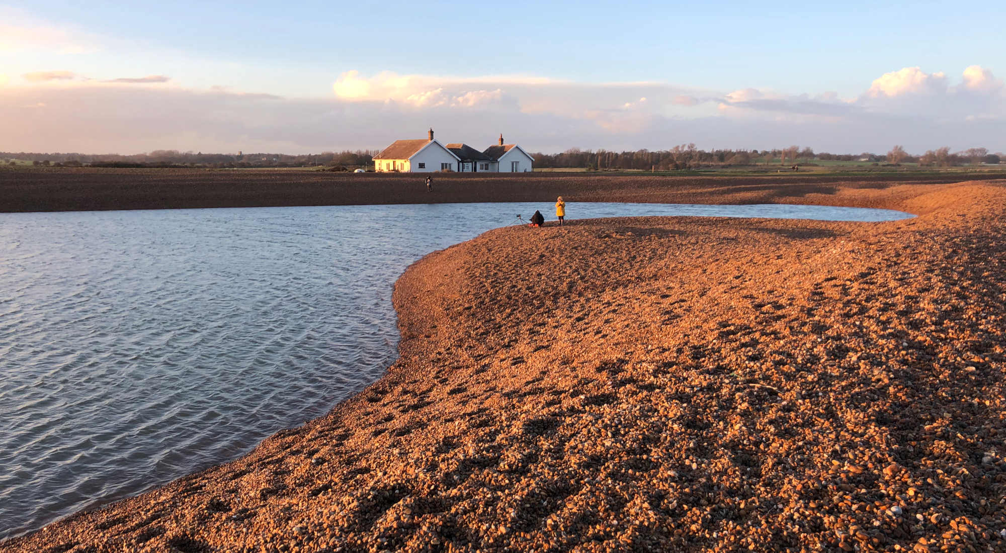 A salt-water lagoon enclosed by shingle banks